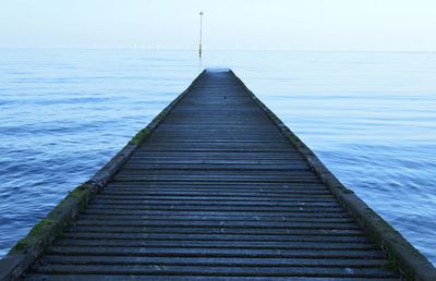 Surface level of wood paneled jetty at calm sea