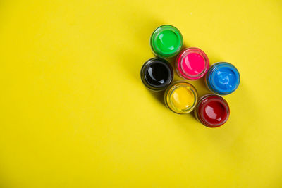 High angle view of multi colored pencils on yellow table