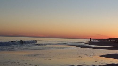 Scenic view of sea against clear sky during sunset