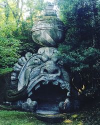 Statue amidst trees against plants