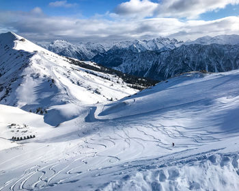 Scenic view of snow covered mountains against sky