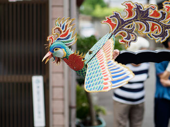 Close-up of colorful bird sculpture