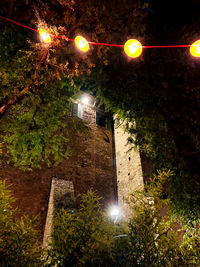 Low angle view of illuminated street light at night