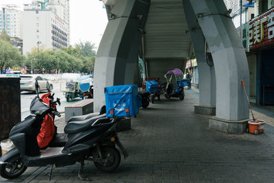 People on street amidst buildings in city