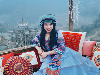 Portrait of smiling woman with umbrella in winter