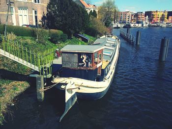 Boats in river with buildings in background