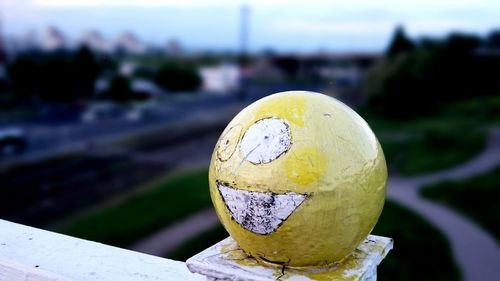 High angle view of yellow ball on railing