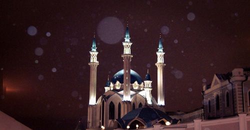 Low angle view of buildings in city at night