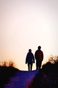 Rear view of woman looking at sunset