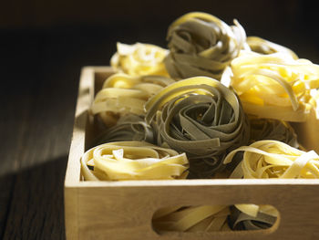 Directly above shot of tagliatelle pasta in crate on table