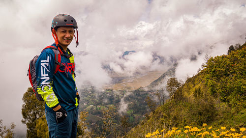 Man standing on mountain against sky