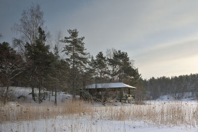Scenic view of house and trees against sky during winter