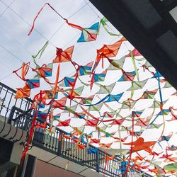 Low angle view of colorful decoration hanging against sky
