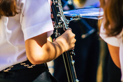 Midsection of woman playing musical equipment