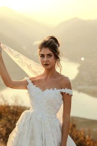 Portrait of young woman standing outdoors