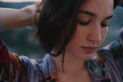 Close-up portrait of young woman looking away