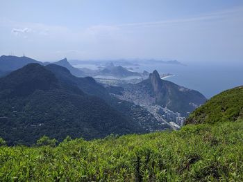 Scenic view of mountains against cloudy sky