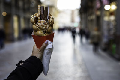 Close-up of hand holding ice cream cone