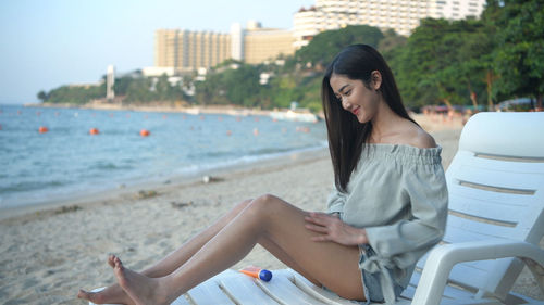 Young woman sitting on beach