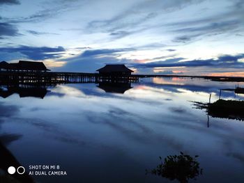 Scenic view of lake against sky at sunset