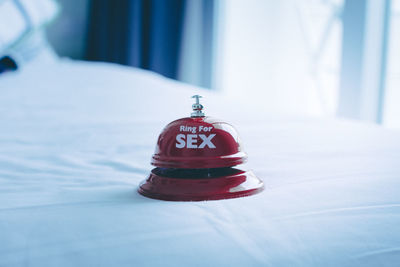 Close-up of service bell with text on bed