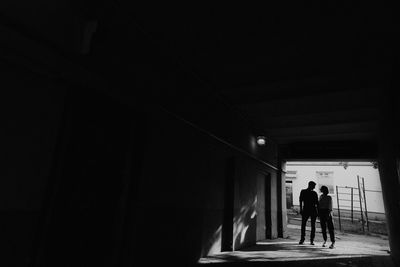 Rear view of silhouette people walking in building