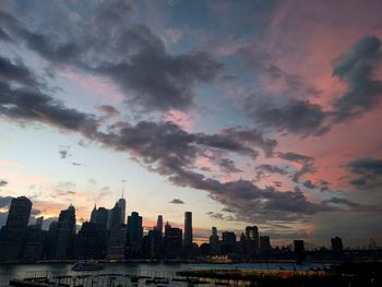 Cityscape against cloudy sky