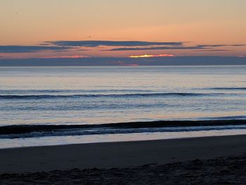 Scenic view of beach against sky during sunset