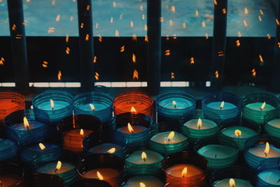 Close-up of illuminated candles in temple