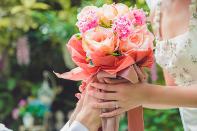 Bouquet in the hands of the groom. to make a happy wedding gift to a young bride.