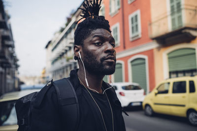 Portrait of young man looking at city