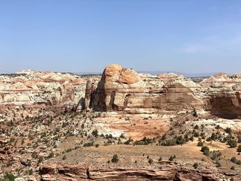 Rock formations on landscape against sky