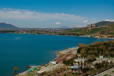 High angle view of townscape by sea against sky