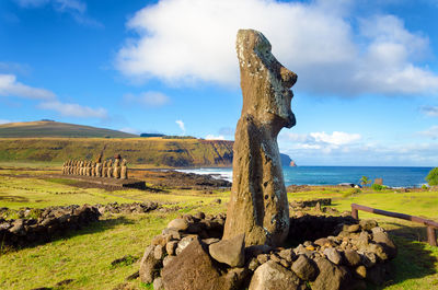 Ancient statue against cloudy sky