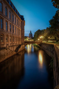 Reflection of illuminated buildings in water at night