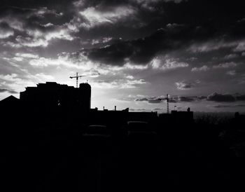 Buildings against cloudy sky at sunset