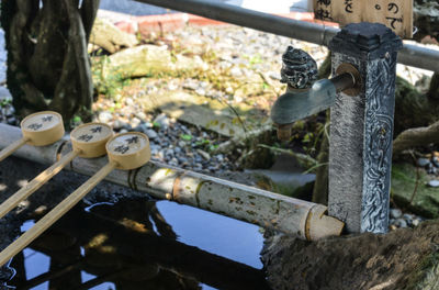 Close-up of water fountain with bamboo ladles