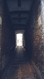 Empty narrow corridor along buildings