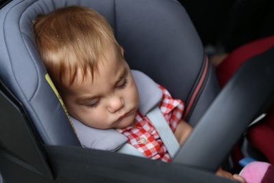 Close-up of cute baby boy sleeping in stroller