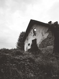 Low angle view of old abandoned building against sky