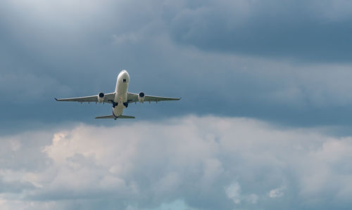 Airplane flying on blue sky and white fluffy cloud. commercial airline with dream destinations.