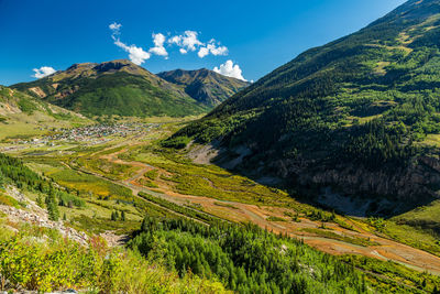 Scenic view of mountains against blue sky