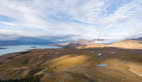 Drone view of lake tekapo and the surrounding grassland landscape, south island, new zealand