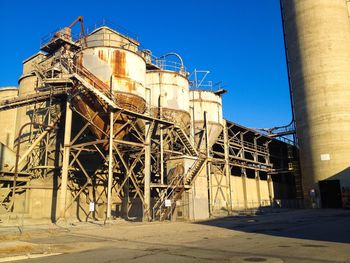 Low angle view of built structure against clear blue sky