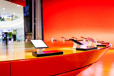 Close-up of illuminated laptop on table in restaurant