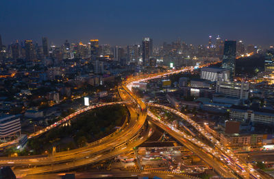 High angle view of illuminated city against sky at night