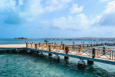 Pier over sea against sky