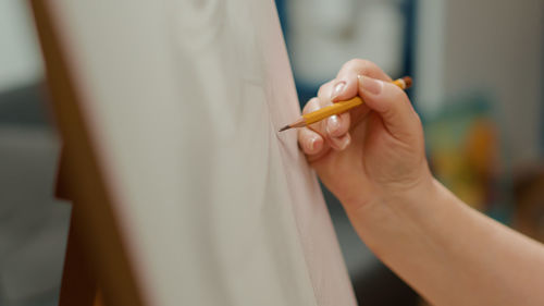 Cropped hand of woman using mobile phone