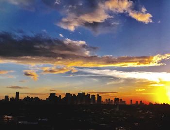 Silhouette buildings against sky during sunset