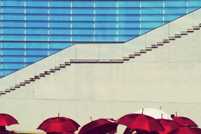 Red umbrellas against building